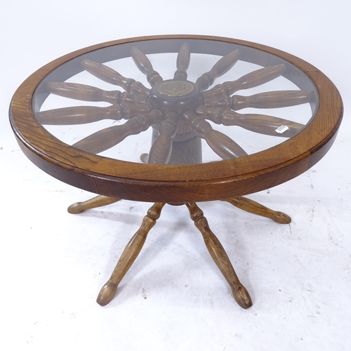 2070 - An oak ship's wheel coffee table, with an inset glass top, W64cm, H40cm