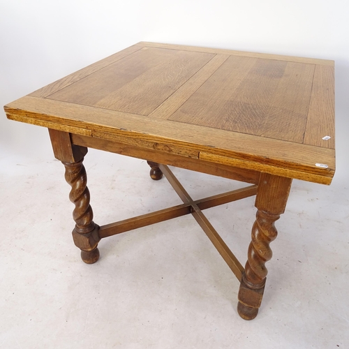 2138 - A golden oak draw leaf table, on barley twist legs and cross stretchers, L92cm, H73cm