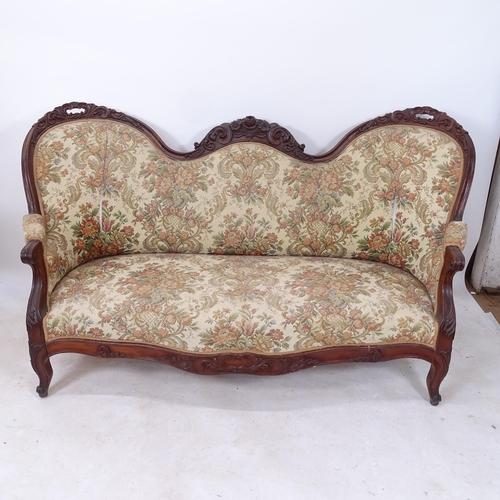 2179 - A Victorian carved and mahogany-framed double spoon-back serpentine-front settee, L180cm