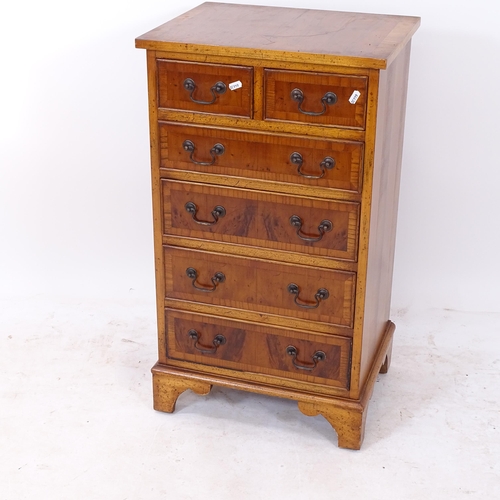 2181 - A reproduction crossbanded yew wood narrow chest, with 2 short and 4 long drawers, on bracket feet, ... 