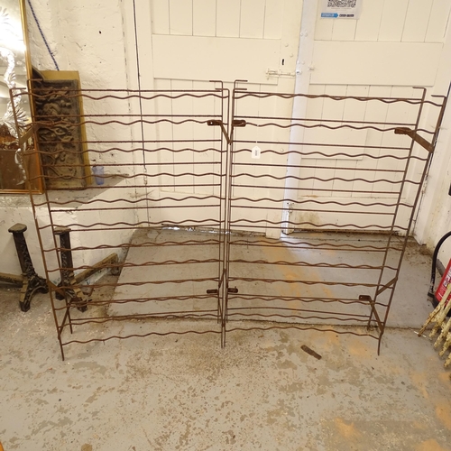 2688 - A pair of cast-iron bottle racks, W74cm, H121cm