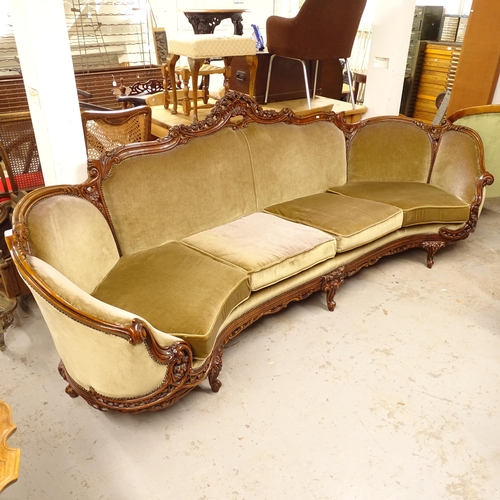 2699 - A large bow-end 4-seater settee of serpentine form, with stained beech show-wood, L280cm