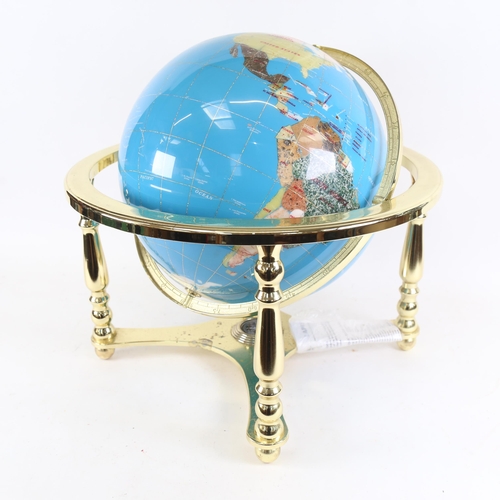 110 - A reproduction brass and hardstone table-top terrestrial globe, with compass inset base, overall hei... 