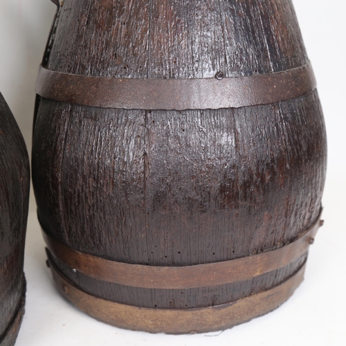 112 - A graduated pair of coopered oak cider flagons, largest height 50cm