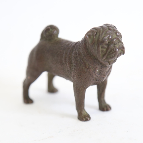 126 - A miniature bronze pug dog, unsigned, length 7cm