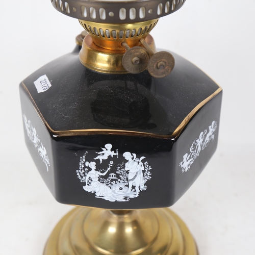 255 - A Duplex brass oil lamp, with ceramic font and glass globe shade and funnel, overall height 55cm