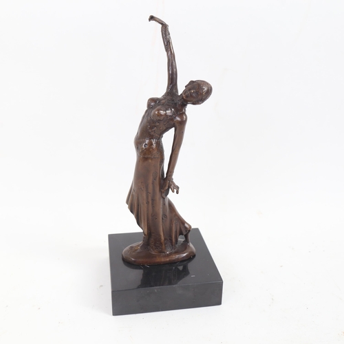 72 - A reproduction bronze sculpture, Art Deco dancing lady, unsigned, on black marble plinth, overall he... 