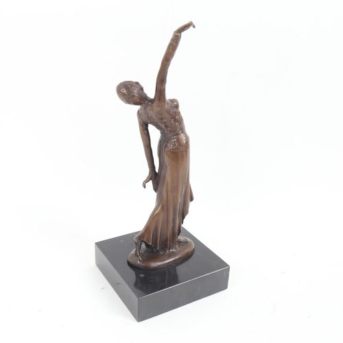 72 - A reproduction bronze sculpture, Art Deco dancing lady, unsigned, on black marble plinth, overall he... 