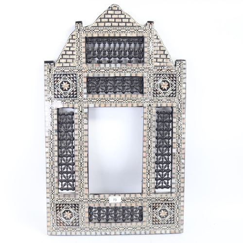 73 - A modern Middle Eastern Moorish mother-of-pearl inlaid frame, 74cm x 45cm, internal dimensions 28cm ... 