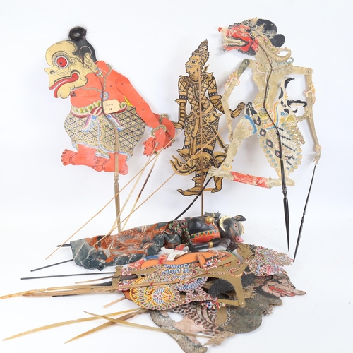 83 - A quantity of Oriental shadow puppets, and a carved and painted wood example