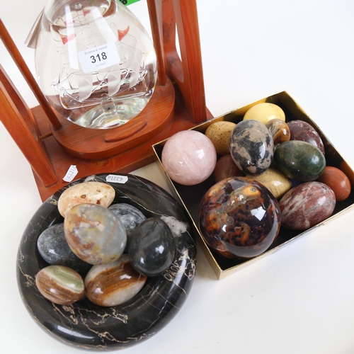 318 - A group of hardstone eggs, veined marble bowl, bottle of Via Roma Distillati Grappa