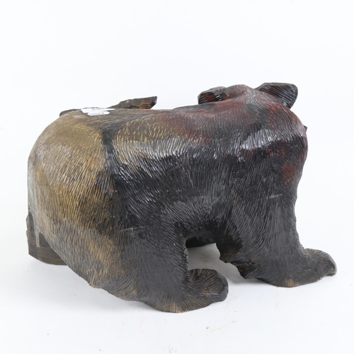 362 - A large carved and painted wood bear with salmon, length 40cm