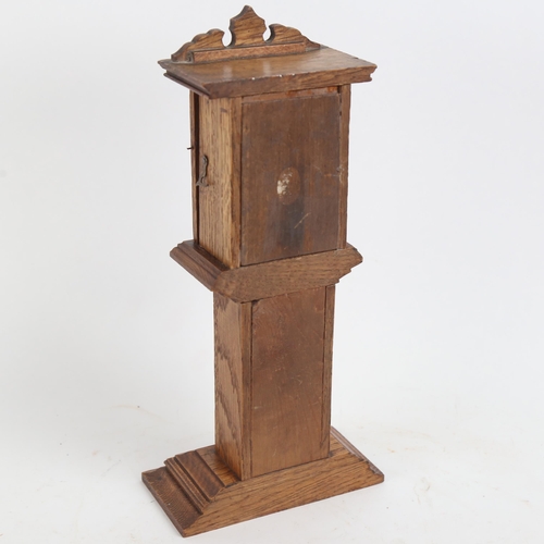 376 - An oak table-top longcase clock pocket watch stand, height 29.5cm