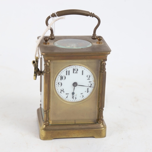 394 - A brass-cased carriage clock, white enamel dial with Arabic numerals, case height 11cm