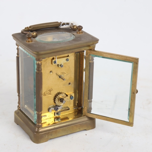 394 - A brass-cased carriage clock, white enamel dial with Arabic numerals, case height 11cm