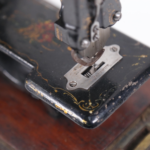 444 - Antique child's sewing machine, with painted and gilded decoration, in original carrying case with b... 