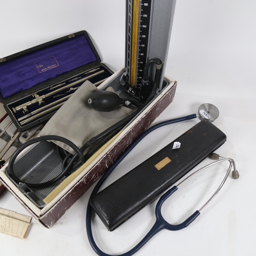 478 - A blood pressure gauge, stethoscope, and 3 cased instruments