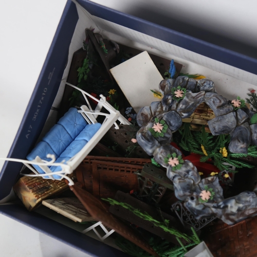 519 - A box containing Britains Floral Garden and other toy garden furniture