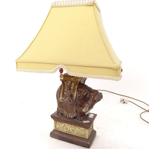 2107 - A decorative composite table lamp and shade, in the form of an Indian elephant, height including sha... 