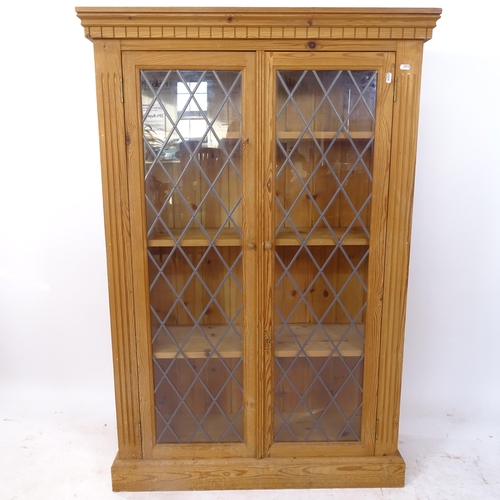 2113 - A pine bookcase with 2 leadlight glazed doors, W90cm, H135cm, D30cm