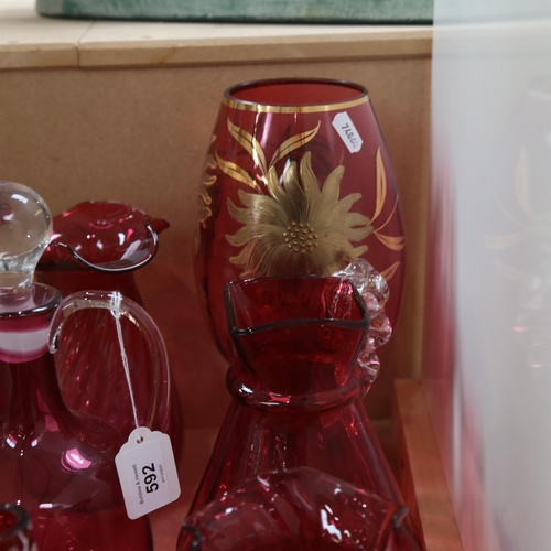 592 - Cranberry glass jug decanter and stopper, 27cm, gilded cranberry glass vase etc