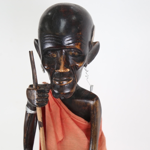 609 - An African carved hardwood figure seated on a stool, 60cm