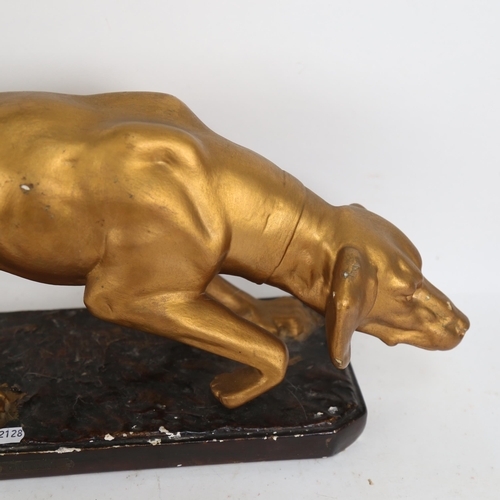 622 - A painted and gilded plaster sculpture of a hound, length 58cm