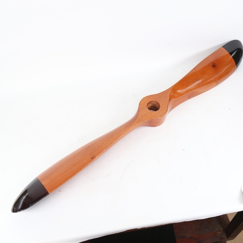 655 - A polished wood propeller, 29cm