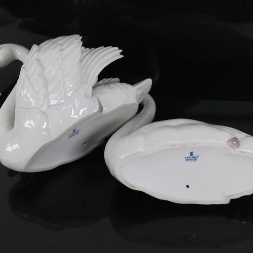 704 - 2 Lladro porcelain swan figures, model no. 5230 and 5231, largest height 21cm