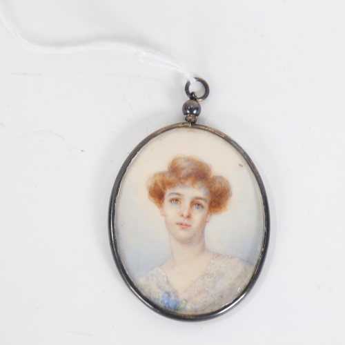 734 - An early 20th century miniature hand painted watercolour portrait, in pendant frame, panel length 6c... 