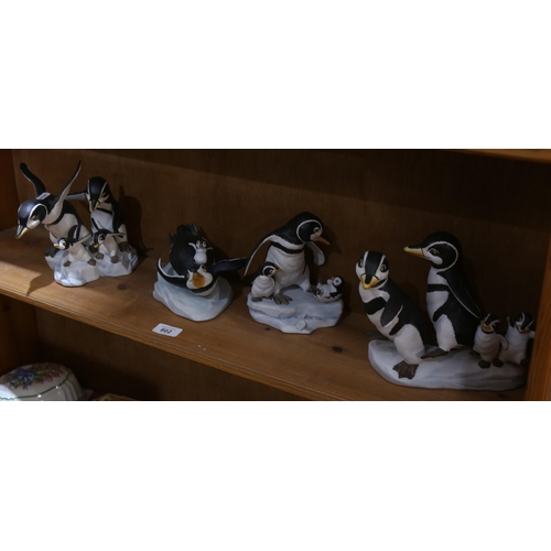 802 - 4 Franklin Mint hand painted porcelain penguin figure groups