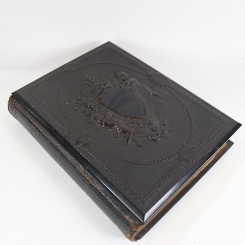 840 - A Victorian album with bois durci covers, containing carte visite, 30cm x 23cm