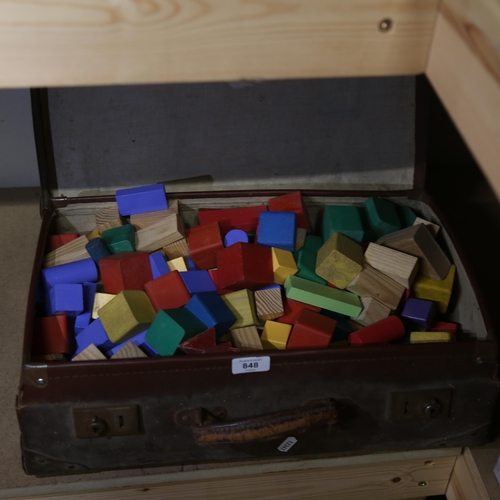 848 - A leather suitcase containing child's building blocks