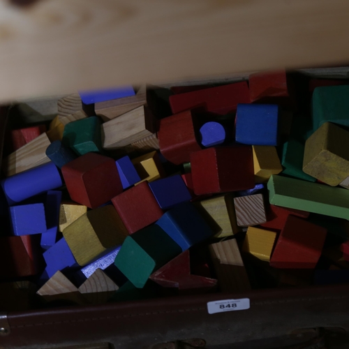 848 - A leather suitcase containing child's building blocks