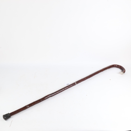 906 - A cherrywood silver-mounted walking stick, length 92cm