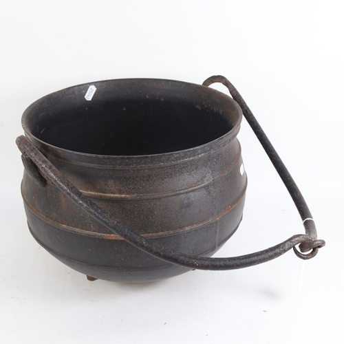 907 - A cast-iron cauldron, with carrying handle, overall width 38cm