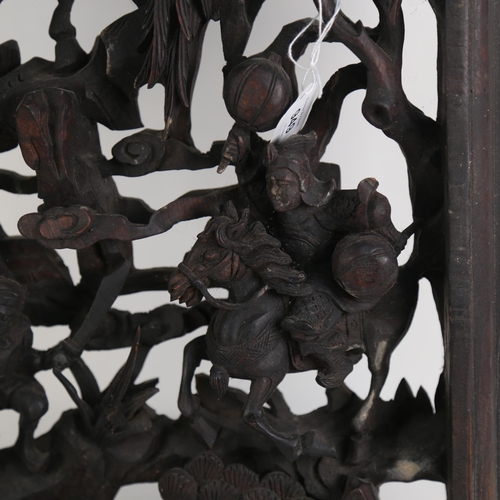 949 - A large Chinese carved and pierced hardwood panel, depicting soldiers on horseback, 100cm x 36cm