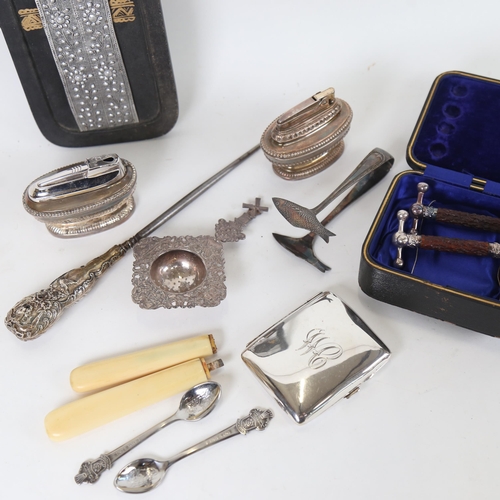 1124 - Cased staghorn knife rests, sardine tongs, tea strainer, lighters, African white metal plaque etc