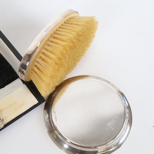 1128 - A modern circular silver pin dish, depicting The Pantiles, and a boxed silver-backed brush and comb ... 