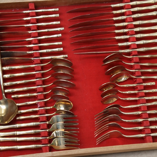 1153 - A canteen of bronze cutlery for 8 people, in a tray-fitted canteen, including serving set, and 2 x e... 