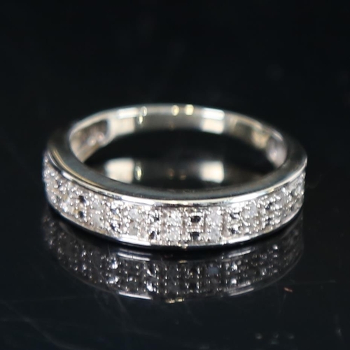 1241 - A 9ct white gold and diamond set half hoop ring