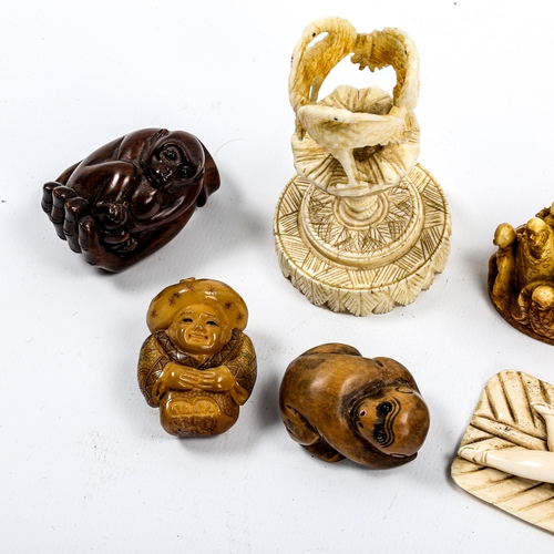 1049 - A group of Oriental ivory and wood netsuke, and an ivory stork design stand (8)