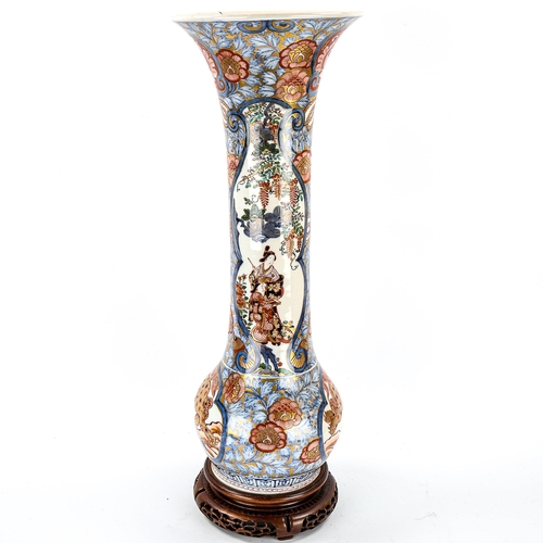 1055 - A Chinese 19th century porcelain sleeve vase, with hand painted and gilded decoration, on original h... 