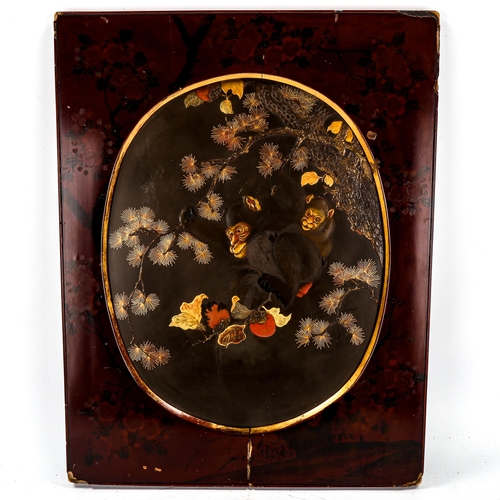 1101 - A Japanese gilded and lacquered wall panel, depicting monkeys and fruit, in original painted red lac... 