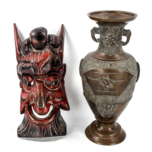 1118 - A Chinese relief moulded bronze vase, height 23cm, and a small carved wood wall mask, length 23cm (2... 