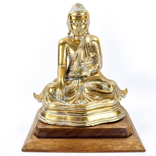 1119 - A Chinese polished bronze seated Buddha on wood plinth, height 38cm