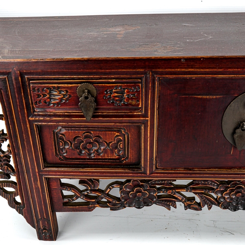 1134 - A Chinese stained wood altar table of small size, with 4 small carved drawers and central cupboard f... 