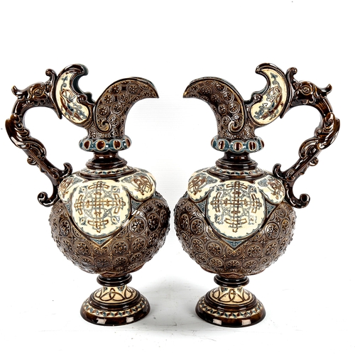 1142 - A pair of 19th century Hungarian pottery ewers, with relief moulded decoration, height 34cm