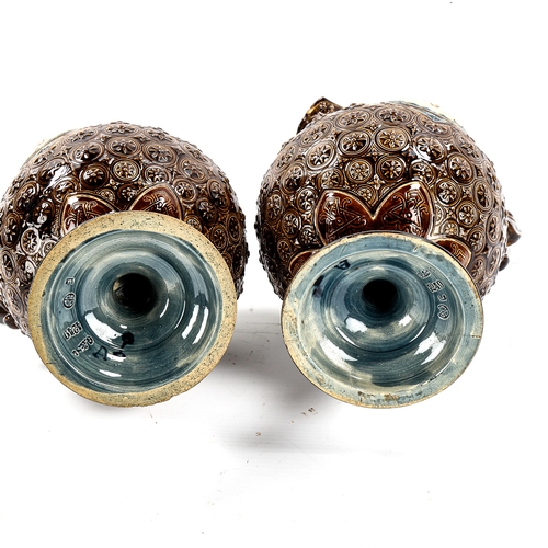 1142 - A pair of 19th century Hungarian pottery ewers, with relief moulded decoration, height 34cm