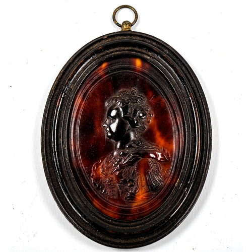 1166 - A pressed tortoiseshell plaque, depicting Queen Anne, by O Brisset, 1705, oval ebony frame overall 1... 